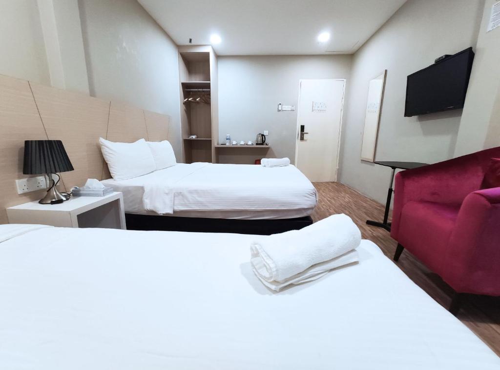 Postel nebo postele na pokoji v ubytování Princess Hotel Pontian