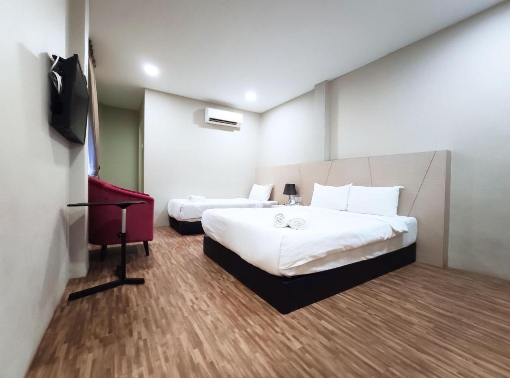 Postel nebo postele na pokoji v ubytování Princess Hotel Pontian