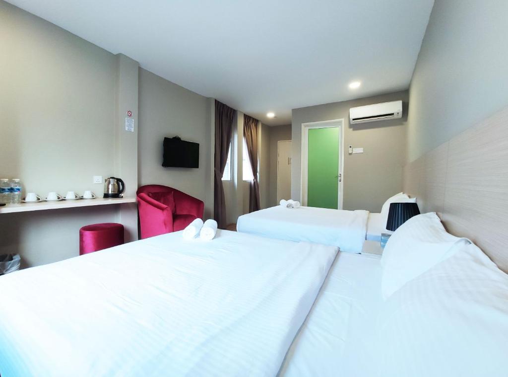 Postel nebo postele na pokoji v ubytování Princess Hotel Pontian