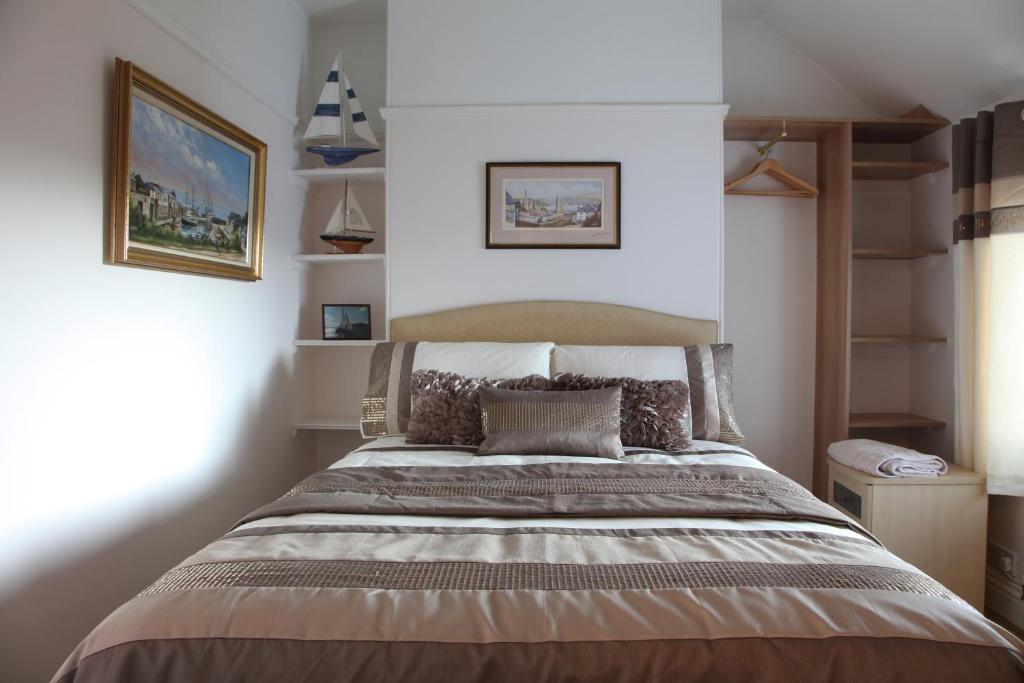 a bedroom with a large bed in a room at Langdale House in St Austell