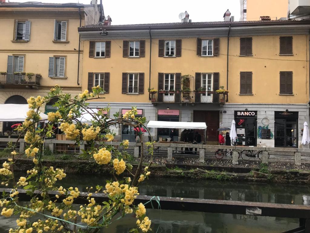 a group of buildings in a city with a river at Lovelyloft - Alzaia Naviglio in Milan
