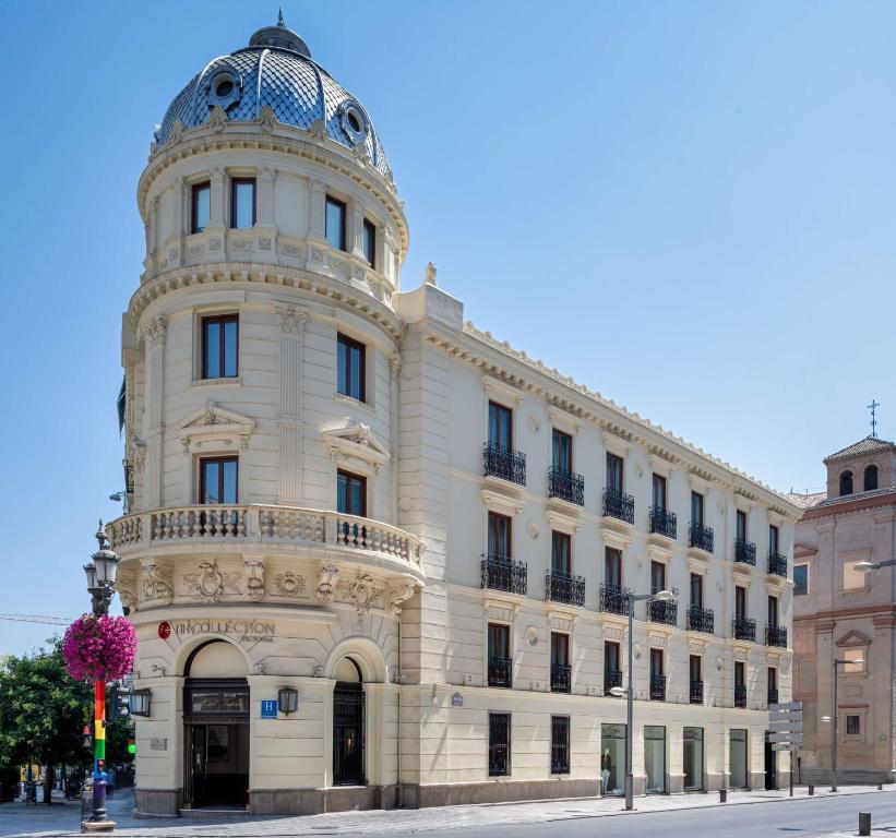 a large building with a clock on the front of it at NH Collection Victoria in Granada