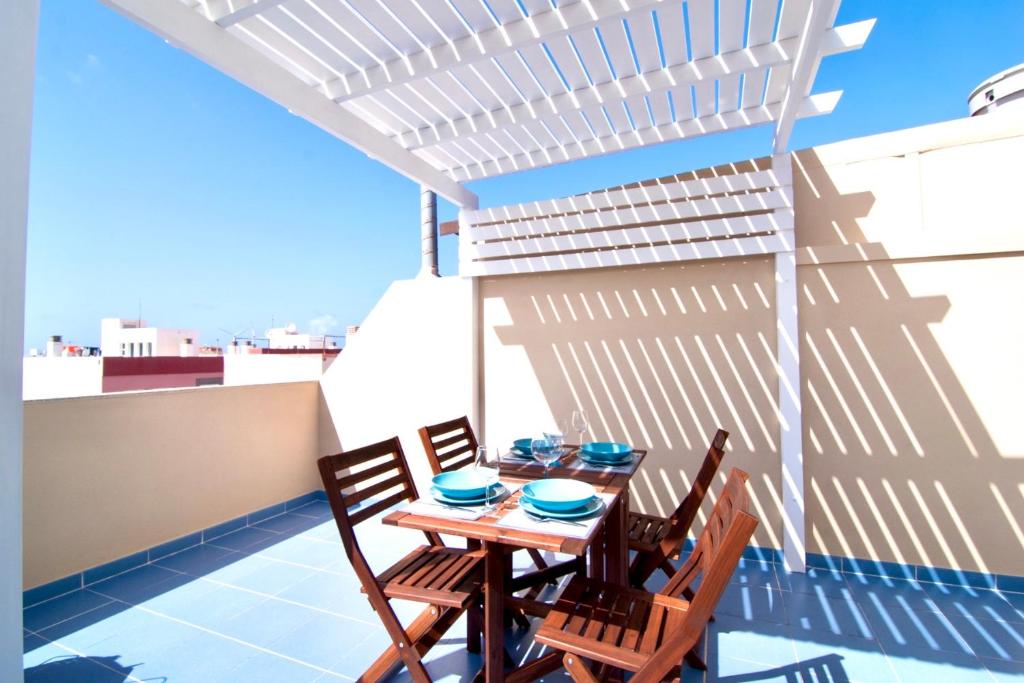a table and chairs on the balcony of a building at Red Surf Home in Corralejo