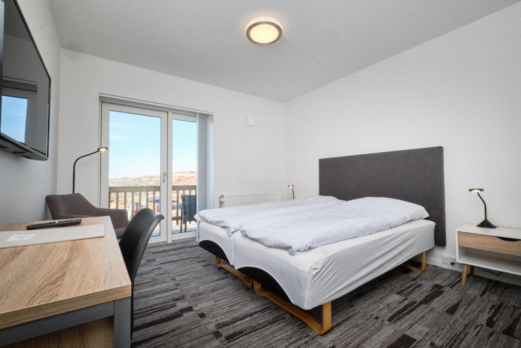 En eller flere senge i et værelse på Icefiord Apartments