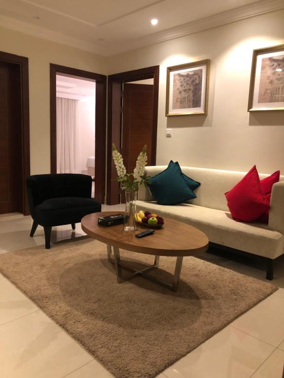 a living room with a couch and a coffee table at Dar Al Maamon Furnished Apartment in Jeddah