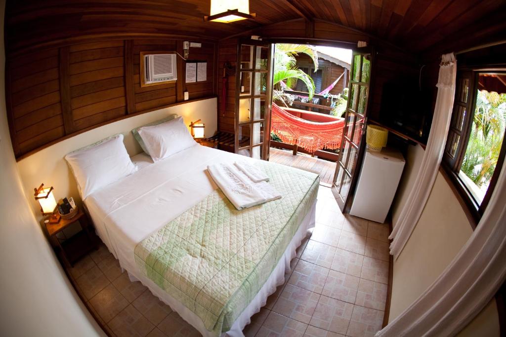 Cama ou camas em um quarto em Complexo de Pousadas Caraguatá
