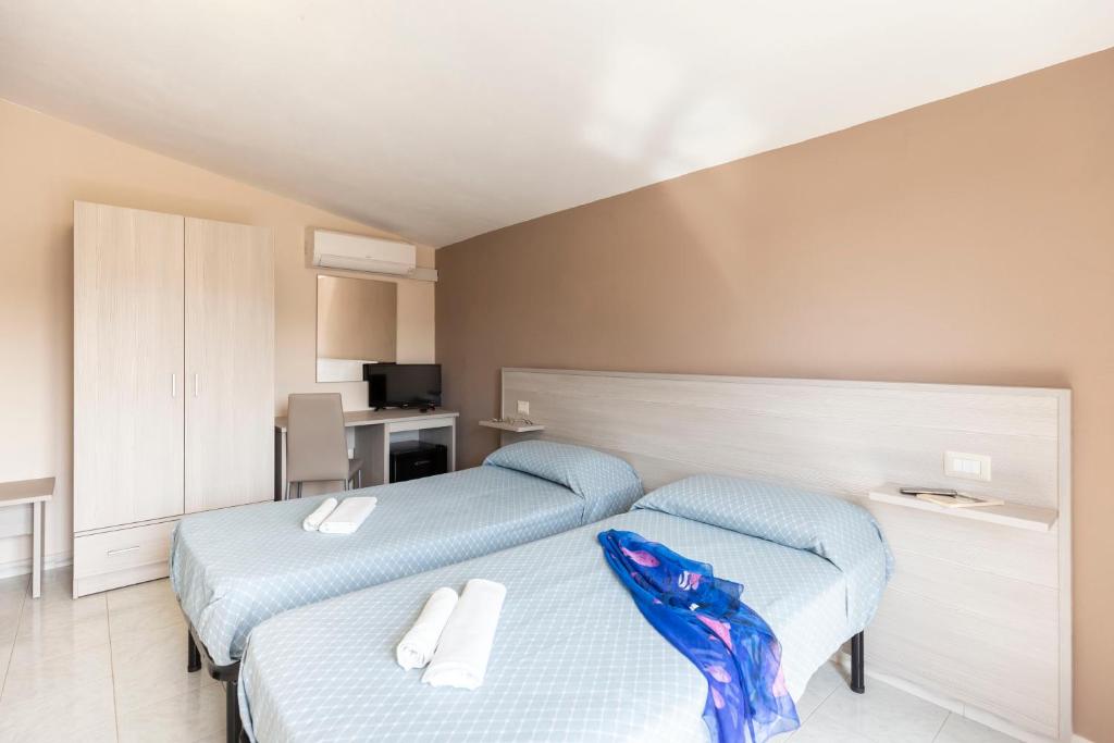 Łóżko lub łóżka w pokoju w obiekcie Hotel La Fattoria Sul Mare