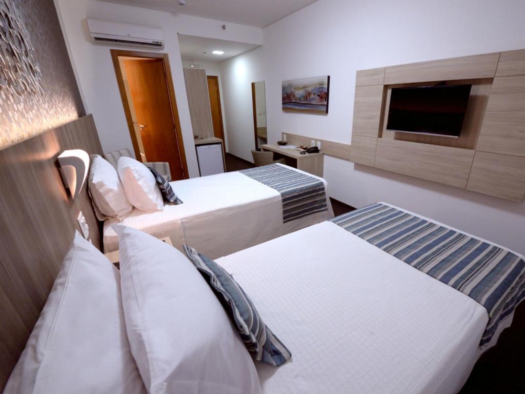Postel nebo postele na pokoji v ubytování Allia Gran Pampulha Suites