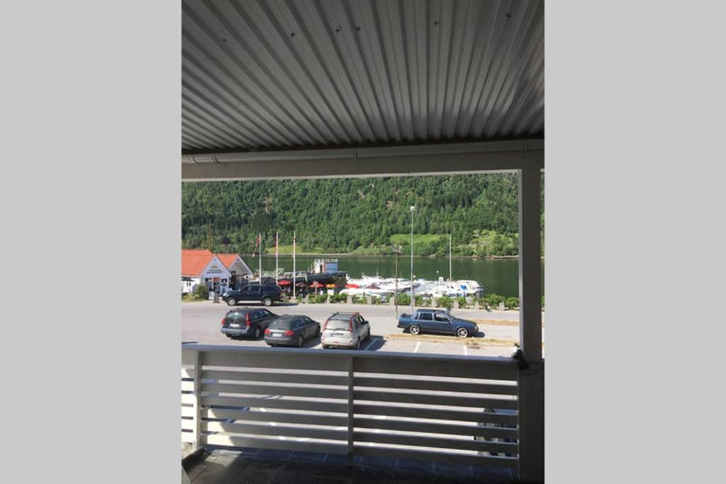 a garage with cars parked in a parking lot at Balestrand Fjordapartments Holmen 19A in Balestrand