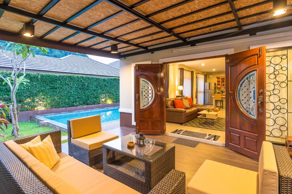 an outdoor living room with a pool and furniture at A-One Pool Villa Aonang Krabi in Ao Nang Beach