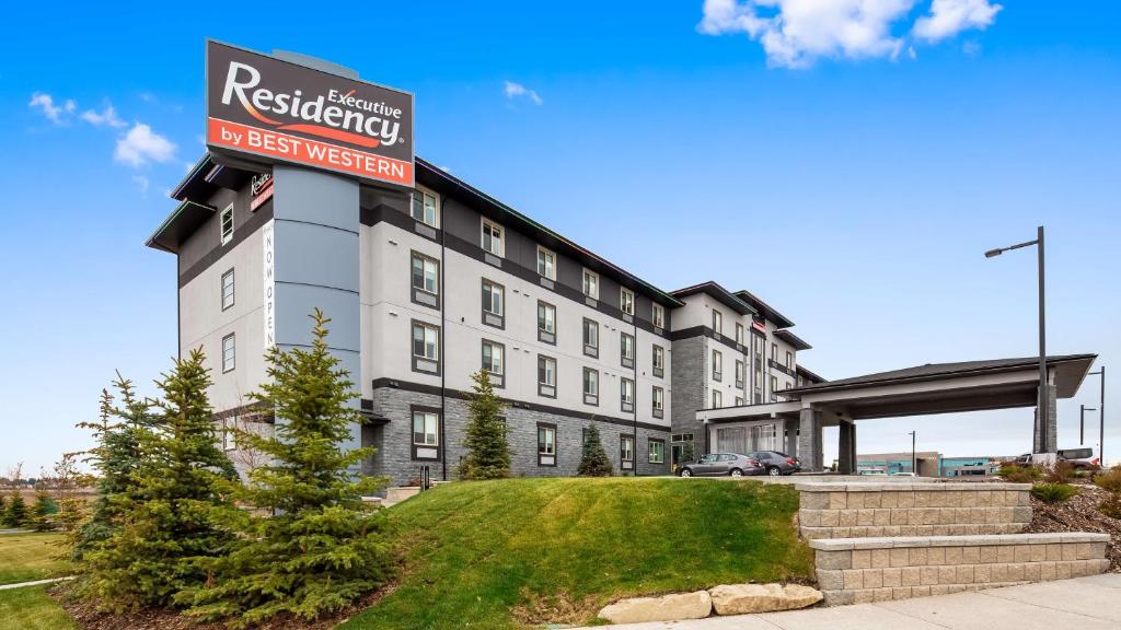 a building with a sign for a hotel at Executive Residency by Best Western Calgary City View North in Calgary