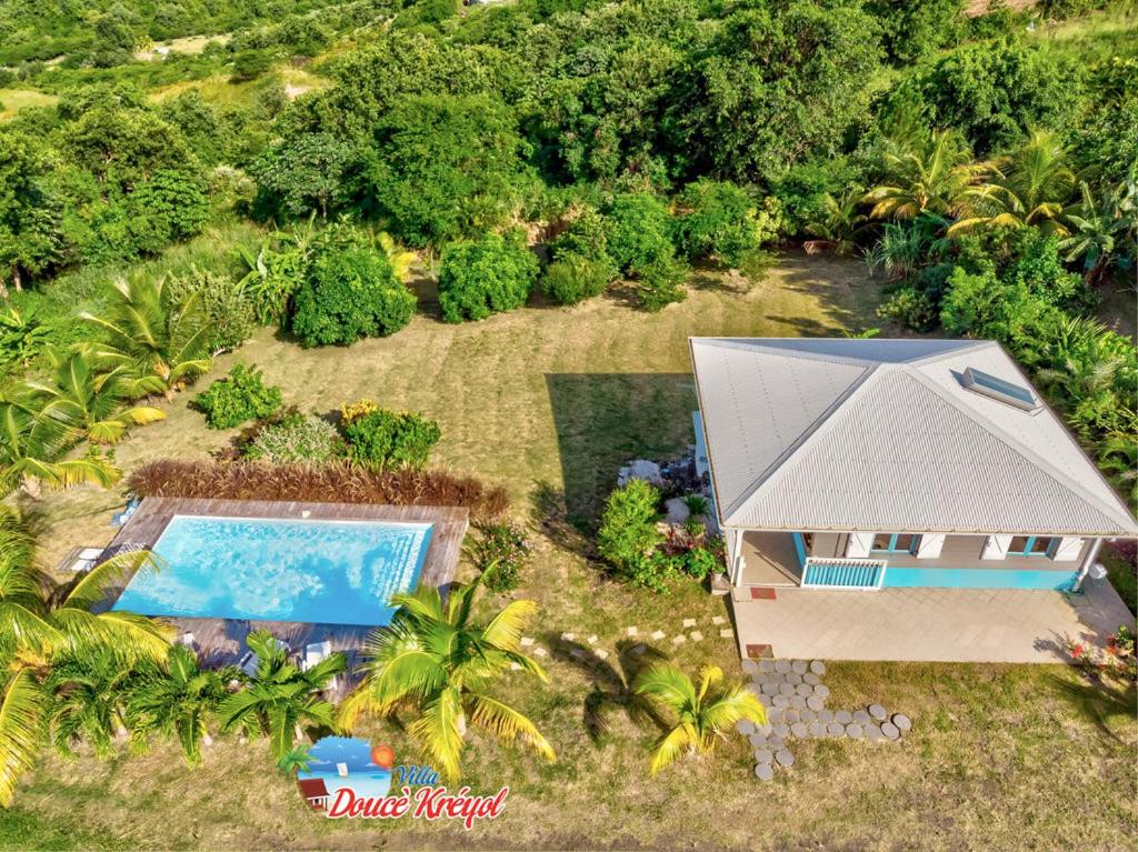 an aerial view of a house with a swimming pool at Villa "Doucè Kréyol" in Le Marin