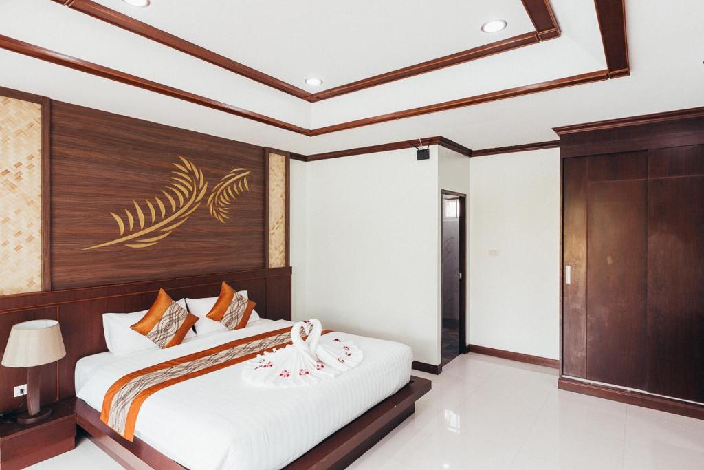 Postel nebo postele na pokoji v ubytování Palm Kiri Aonang Resort
