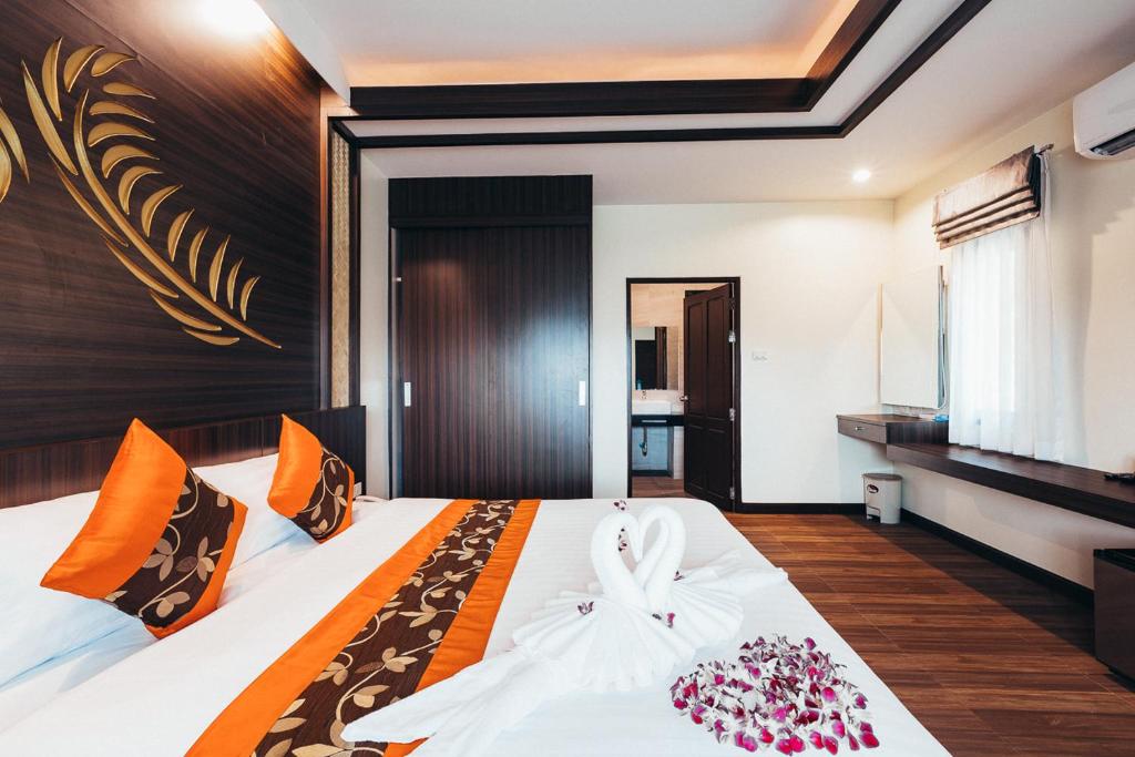 Postel nebo postele na pokoji v ubytování Palm Kiri Aonang Resort