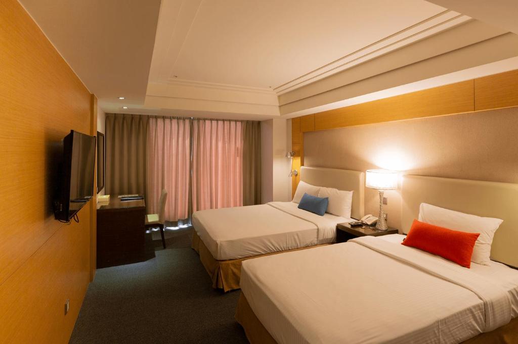 Postel nebo postele na pokoji v ubytování Ever Delightful Business Hotel