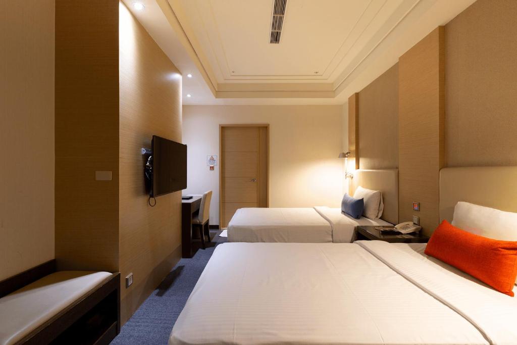 Postel nebo postele na pokoji v ubytování Ever Delightful Business Hotel