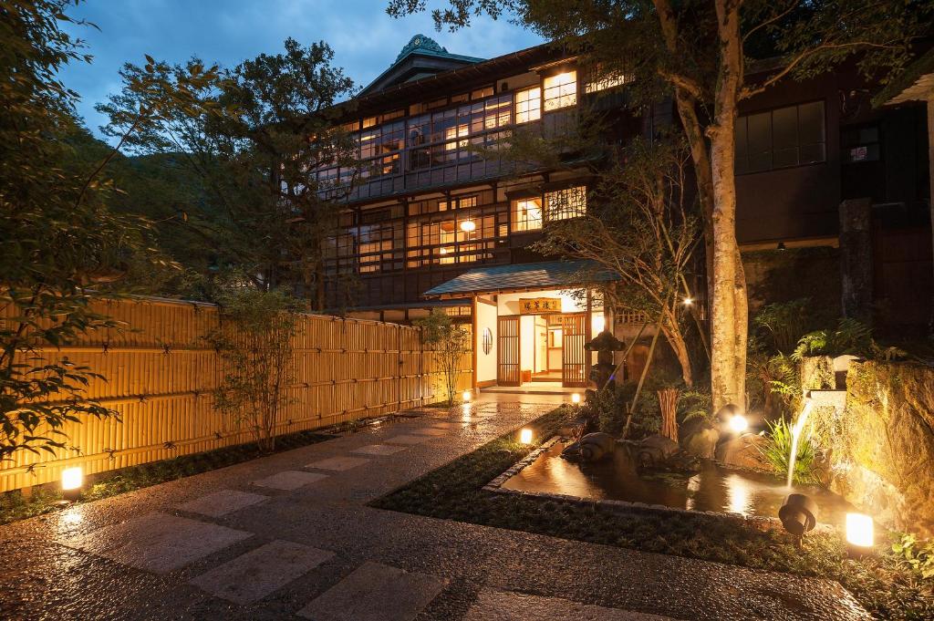 an external view of a building at night with lights at KANSUIRO ANNEX in Hakone