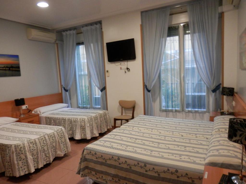 En eller flere senge i et værelse på Hostal del Pez Azul