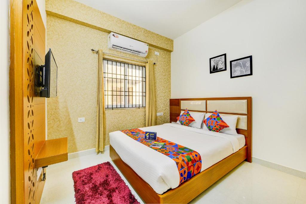 a bedroom with a large bed and a window at FabHotel Sky Bay in Chennai