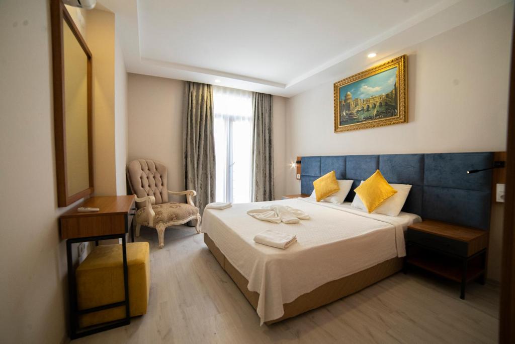 a hotel room with a bed and a chair at Sirena Apart & SPA in Antalya