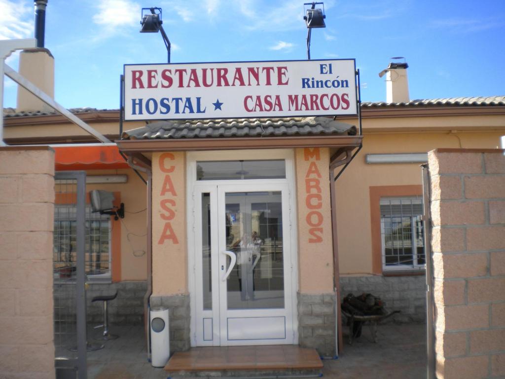 a restaurant with a sign above the door of a building at Hostal El Rincón - Casa Marcos in Yepes