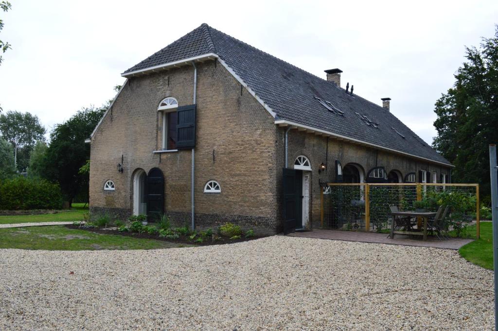 a large brick building with a wooden roof at B&B de Bievangh in Breda