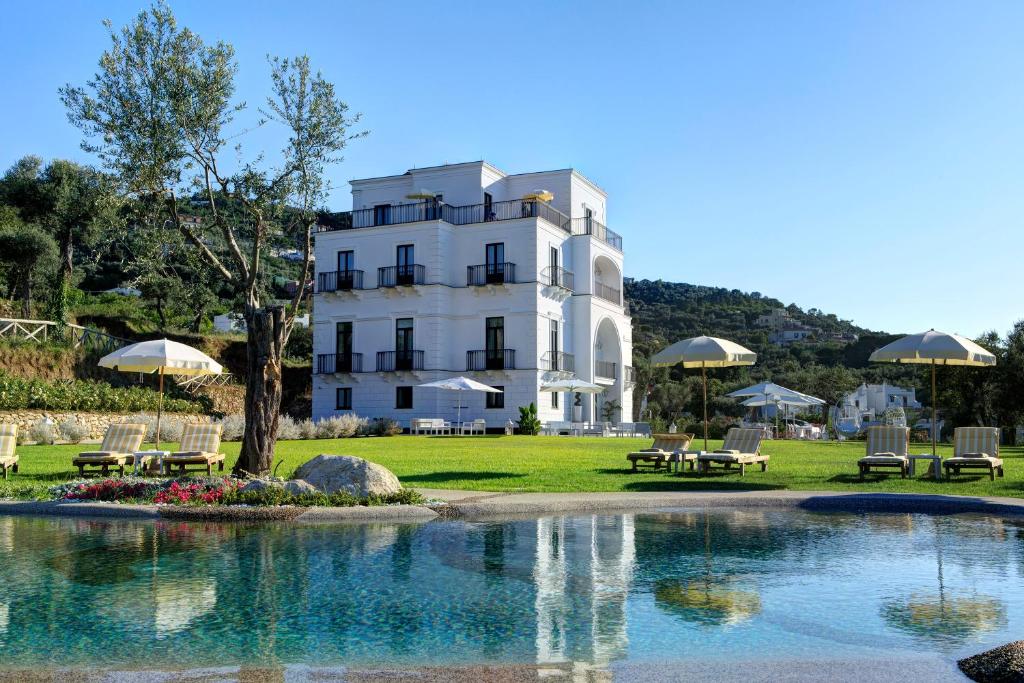 un hotel con piscina frente a un edificio en Anna Belle Elegant AgriResort, en Sorrento