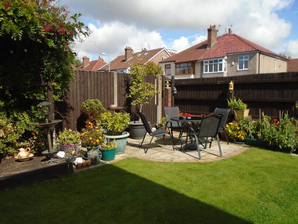 a patio with a table and chairs in a garden at TEA in Liverpool - Private - Quiet - Ground Floor - En-suite - Walk-in-shower in Liverpool