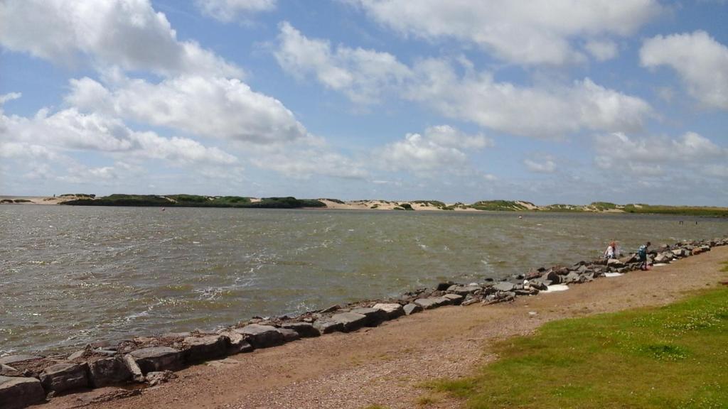 a group of people standing on the shore of a body of water at TEA in Liverpool - Private - Quiet - Ground Floor - En-suite - Walk-in-shower in Liverpool