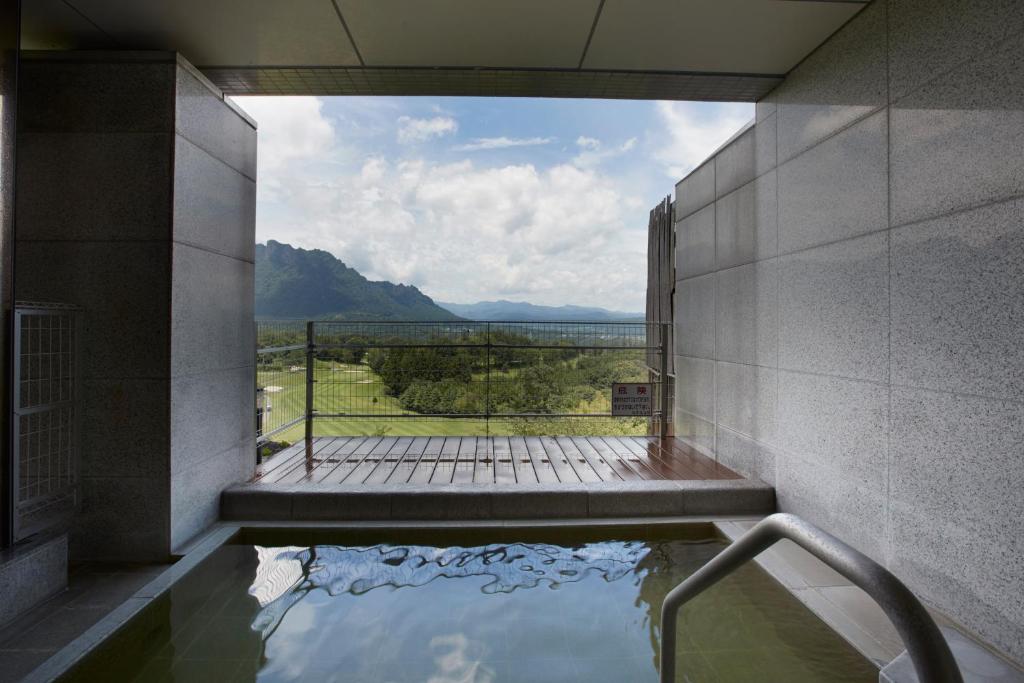 a pool of water in a building with a view at Myogi Green Hotel in Tomioka