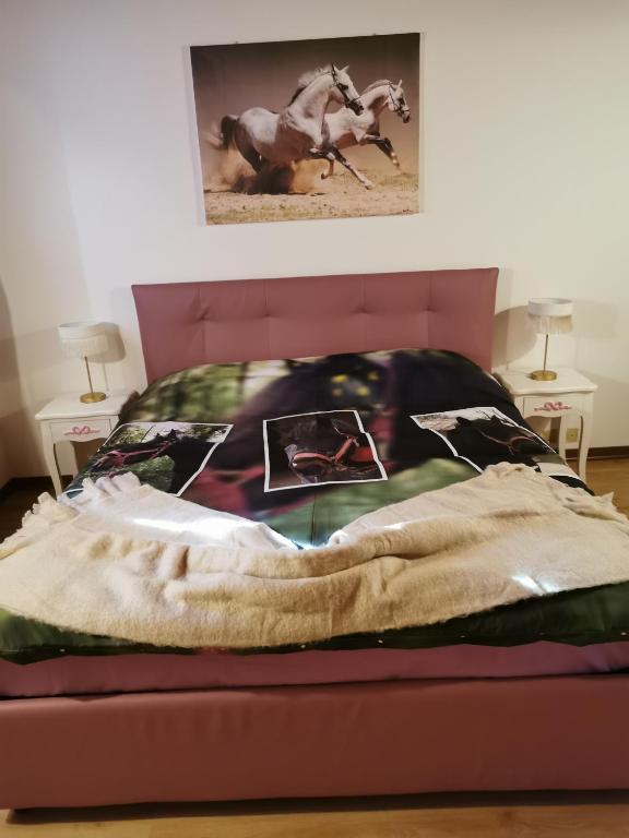a bed with a blanket and a horse on it at Tenuta I Ginepri in Ozzano dell'Emilia