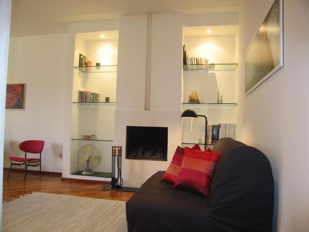 a living room with a couch and a fireplace at Your apartment in the Heart of Florence in Florence