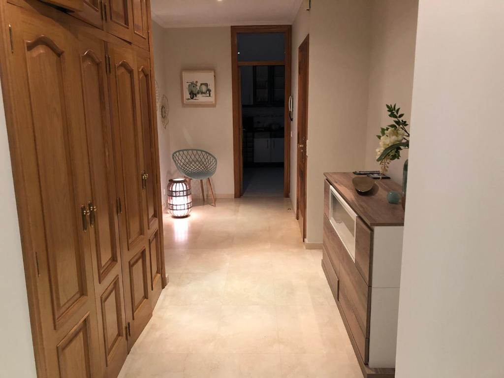 a hallway of a kitchen with a door and a chair at Apartamento mirador de tambo in Combarro