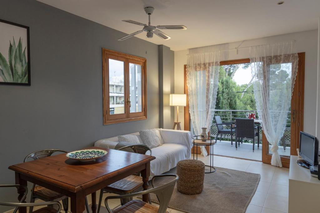 a living room with a couch and a table at APARTAMENTO EL ROJO in Can Picafort