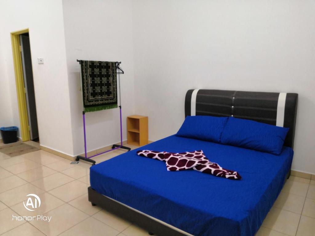 a bedroom with a bed with a giraffe on it at Zara Homestay in Marang