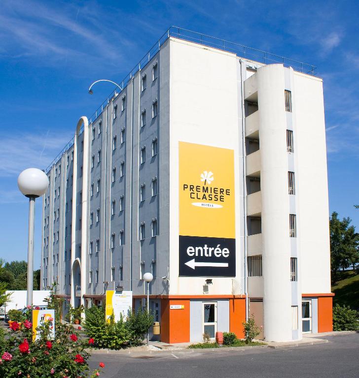 a large building with a sign on the side of it at Premiere Classe Le Blanc Mesnil in Le Blanc-Mesnil