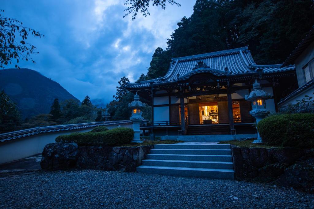 a chinese temple in the mountains at night at 宿坊 端場坊｜Temple Hotel Habanobo in Minobu