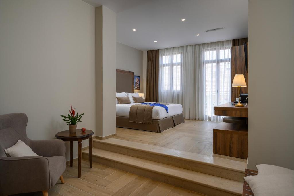 a hotel room with a bed and a living room at Minaret Suites and Apartments in Chania Town