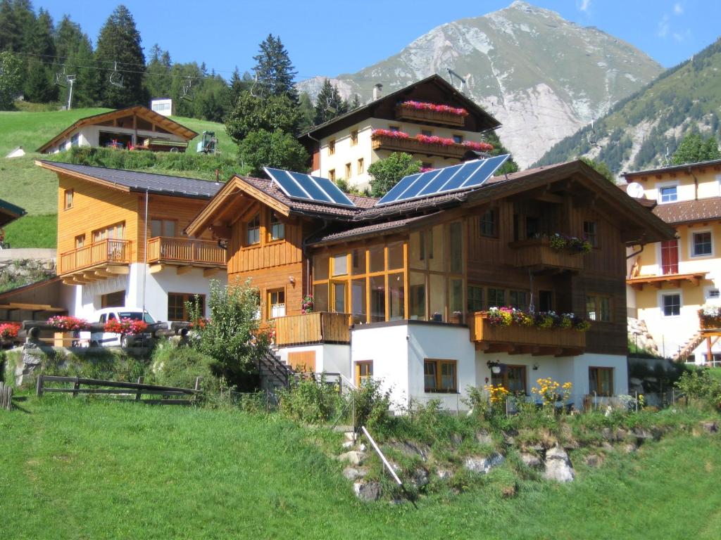 a house with solar panels on top of it at Appartementhaus Sonnleitn in Kals am Großglockner
