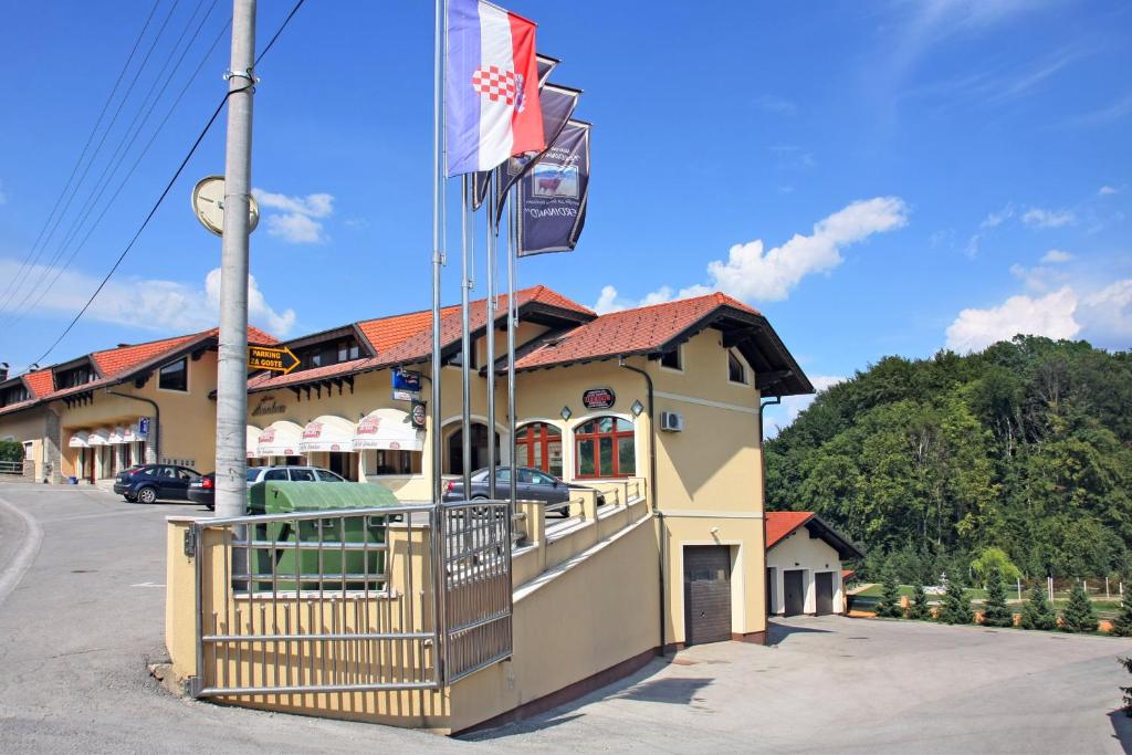 a building with two flags in front of it at Apartments Šoić in Samobor
