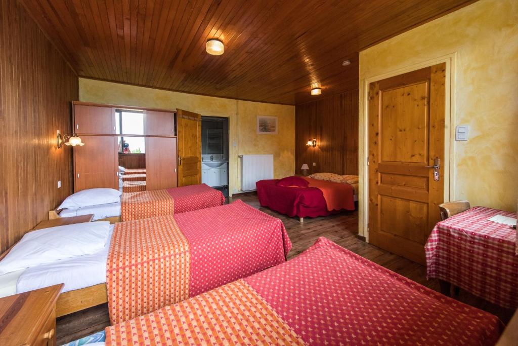 a room with three beds and a room with a room at Les Sorbiers in Montricher-le-Bochet