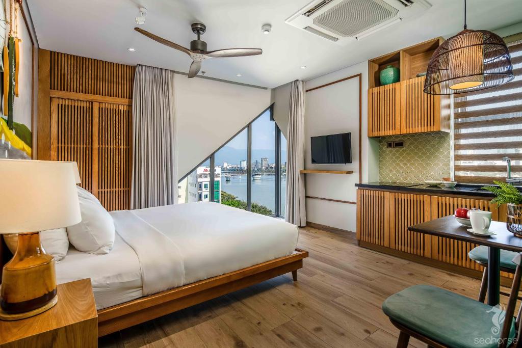 a bedroom with a bed and a view of the water at Seahorse Han Market Da Nang Hostel by Haviland in Da Nang
