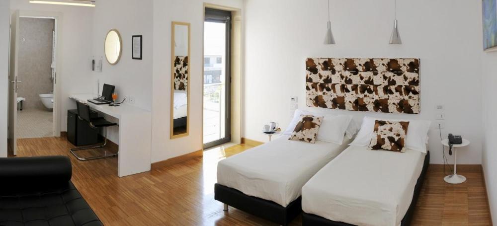 Postel nebo postele na pokoji v ubytování Hotel Del Conte