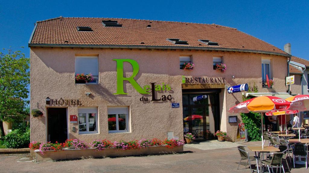 a building with a sign on the side of it at Relais Du Lac in Villegusien Le Lac