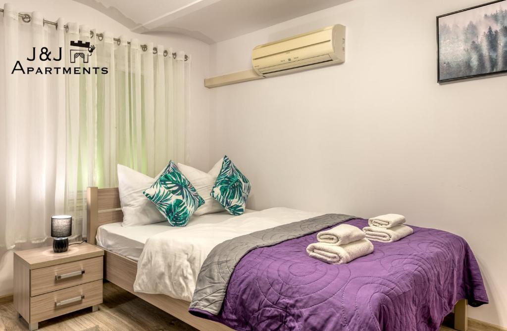 ein Schlafzimmer mit einem Bett mit Handtüchern darauf in der Unterkunft J&J Apartments, Łazienna 30 Apartament 8/1 in Toruń
