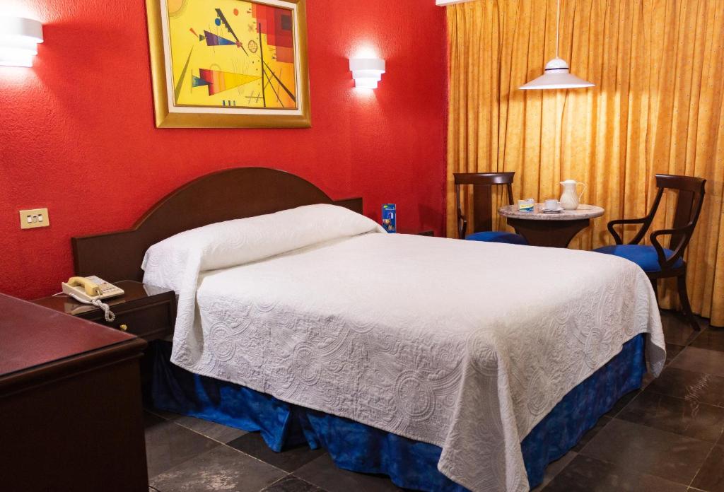 Postel nebo postele na pokoji v ubytování Hotel Tapachula