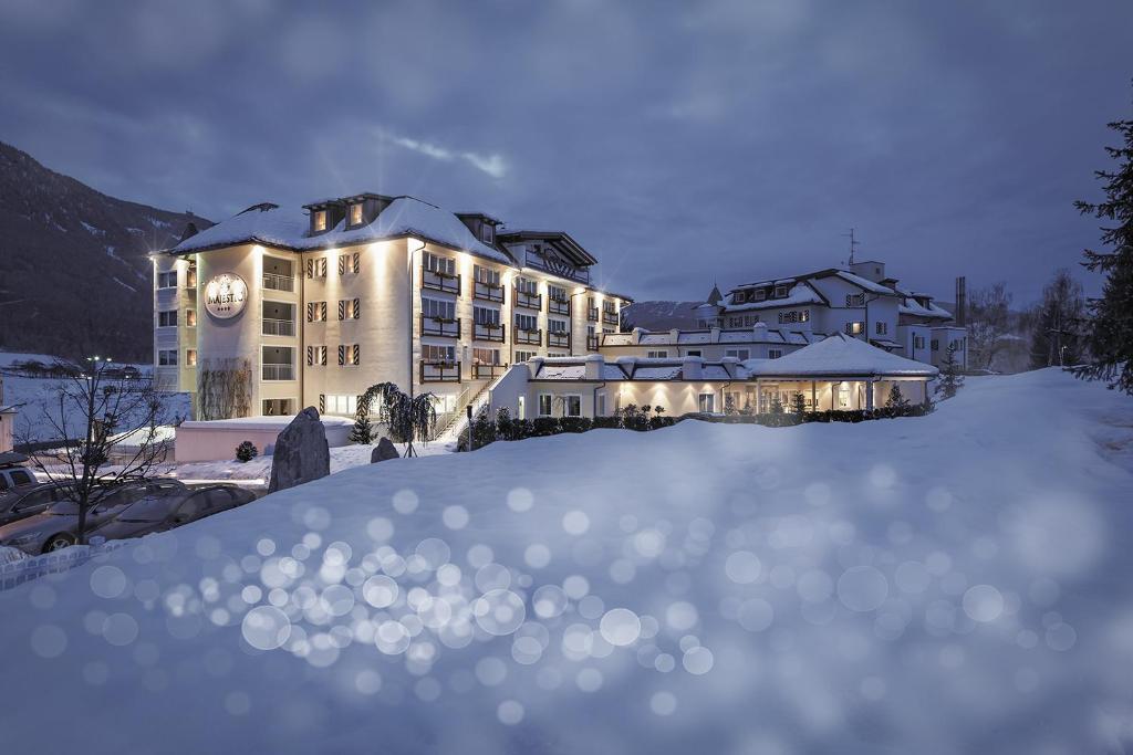 a snow covered ski slope with a train on it at Majestic Hotel & Spa Resort in Brunico