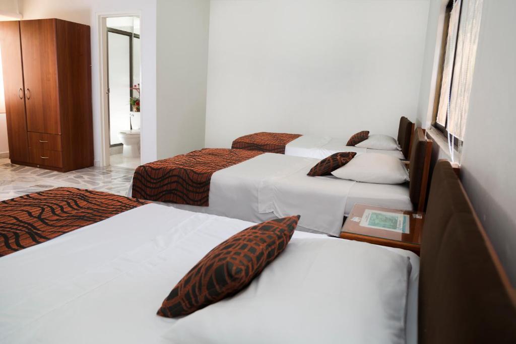 Postel nebo postele na pokoji v ubytování Hotel Flamingo Cali