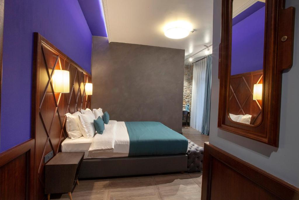 a bedroom with a bed with a purple ceiling at Hotel Solun in Trieste
