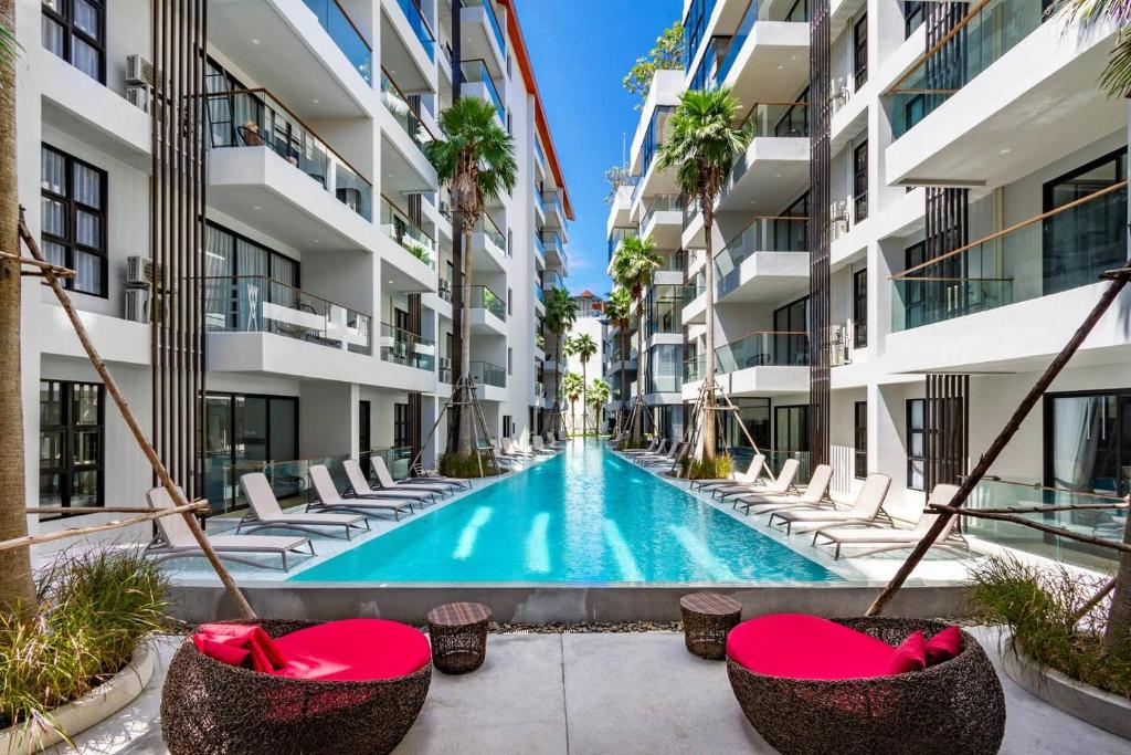 an image of a swimming pool in the middle of a building at PALMYRAH SURIN, MODERN 1BR with Terrace, 150 meters to Surin Beach in Surin Beach